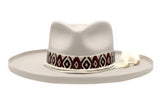 Beige cowboy hat with a patterned band on a white background