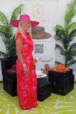Woman wearing pink wide brim floppy straw hat