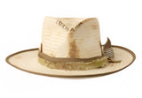 Tan straw fedora with green cloth band on brim 