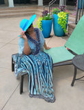 Woman wearing turquoise wide brim floppy straw fedora